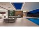 Elegant patio view with a pool, outdoor kitchen, and seamless transition to indoor living spaces at 6623 N Hillside Dr, Paradise Valley, AZ 85253