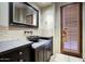 Bathroom with dark vanity and stone sink at 8000 E Mariposa Grande Dr, Scottsdale, AZ 85255