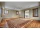 Bright bedroom with hardwood floors, plantation shutters, and access to upper floor at 8000 E Mariposa Grande Dr, Scottsdale, AZ 85255