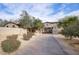 Stone house with gated entry and paved driveway at 8000 E Mariposa Grande Dr, Scottsdale, AZ 85255