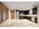 Modern kitchen with dark wood cabinets and stainless steel appliances at 8000 E Mariposa Grande Dr, Scottsdale, AZ 85255