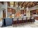Gourmet kitchen with large island and wood beams at 8000 E Mariposa Grande Dr, Scottsdale, AZ 85255