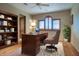 Home office with built-in shelves and hardwood floors at 8000 E Mariposa Grande Dr, Scottsdale, AZ 85255