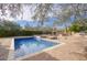 Inviting backyard pool with brick patio and outdoor fireplace at 8000 E Mariposa Grande Dr, Scottsdale, AZ 85255