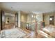 Upper hallway with wood floors and a staircase at 8000 E Mariposa Grande Dr, Scottsdale, AZ 85255