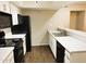 Modern kitchen with black appliances and white cabinets at 1920 W Lindner Ave # 137, Mesa, AZ 85202