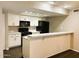 Updated kitchen featuring black appliances and white cabinetry at 1920 W Lindner Ave # 137, Mesa, AZ 85202