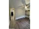 A bedroom has wood-look flooring and a ceiling fan. A walk-in closet provides ample storage in this inviting retreat at 245 S 56Th St # 209, Mesa, AZ 85206