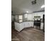 The renovated kitchen offers an eat-in island, stainless appliances, and sleek dark countertops at 245 S 56Th St # 209, Mesa, AZ 85206