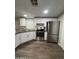 The kitchen features stainless steel appliances, white cabinets, and dark countertops at 245 S 56Th St # 209, Mesa, AZ 85206