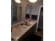 Bathroom showcasing a dual sink vanity with modern fixtures and arch mirrors at 15626 N 50Th St, Scottsdale, AZ 85254