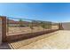 Spacious backyard featuring a wrought iron fence, block wall and low-maintenance desert landscaping at 5678 N 205Th Ln, Buckeye, AZ 85396