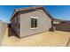 Exterior view of a home's backyard and air conditioning unit at 5678 N 205Th Ln, Buckeye, AZ 85396