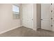 Bedroom showcasing wood-look tile floors, a window, and a closet with sliding doors at 5678 N 205Th Ln, Buckeye, AZ 85396