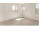 Bright, empty bedroom with tile floors and multiple bright windows at 5678 N 205Th Ln, Buckeye, AZ 85396