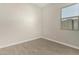 Bright bedroom featuring wood-look tile flooring and a window allowing natural light at 5678 N 205Th Ln, Buckeye, AZ 85396