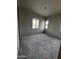 Bedroom under construction boasts natural light with unfinished walls and concrete floors at 5678 N 205Th Ln, Buckeye, AZ 85396