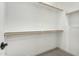 A large, bright white walk-in closet with several wooden rods at 5678 N 205Th Ln, Buckeye, AZ 85396