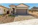 Beautiful home with a paved driveway and desert landscaping for low maintenance at 5678 N 205Th Ln, Buckeye, AZ 85396
