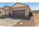 New home with desert landscaping and a brick paver driveway for a modern look at 5678 N 205Th Ln, Buckeye, AZ 85396