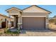 Charming single-Gathering home featuring a brick driveway, neutral color palette, and a convenient two-car garage at 5678 N 205Th Ln, Buckeye, AZ 85396