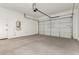 Spacious two car garage with white walls and concrete flooring at 5678 N 205Th Ln, Buckeye, AZ 85396