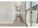 Bright hallway featuring stylish tile floors, neutral walls, and a sliding glass door to the outside at 5678 N 205Th Ln, Buckeye, AZ 85396