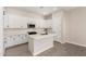 Bright kitchen featuring white cabinets, stainless appliances, a gas range, and an island at 5678 N 205Th Ln, Buckeye, AZ 85396