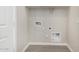 Laundry room with hookups for a washer and dryer and tile flooring at 5678 N 205Th Ln, Buckeye, AZ 85396