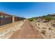 Community walking path showcasing desert landscaping between homes in a residential neighborhood at 5678 N 205Th Ln, Buckeye, AZ 85396