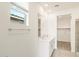 Modern bathroom featuring double sinks, a large mirror, and a walk-in shower at 16025 W Cottontail Ln, Surprise, AZ 85387