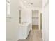 Bathroom featuring a double sink vanity, walk-in closet, and tiled shower at 16025 W Cottontail Ln, Surprise, AZ 85387