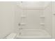 This bathtub offers a shower head and in-wall storage shelves at 16025 W Cottontail Ln, Surprise, AZ 85387