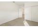 This bedroom features neutral carpeting, closet, and bright white trim at 16025 W Cottontail Ln, Surprise, AZ 85387