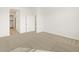 Spacious carpeted bedroom with a walk-in closet and neutral walls at 16025 W Cottontail Ln, Surprise, AZ 85387
