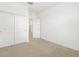 Cozy bedroom with neutral carpeting, closet, and bright white trim at 16025 W Cottontail Ln, Surprise, AZ 85387