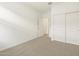 This bedroom features neutral carpeting, closet, and bright white trim at 16025 W Cottontail Ln, Surprise, AZ 85387