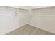 Walk-in closet with carpet and ample shelving for storage at 16025 W Cottontail Ln, Surprise, AZ 85387