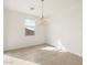Bright dining room features tile flooring, large window, and a stylish chandelier at 16025 W Cottontail Ln, Surprise, AZ 85387