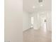 Long tiled hallway with doors leading to bedrooms, bathrooms, and other living spaces at 16025 W Cottontail Ln, Surprise, AZ 85387