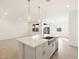 Open-concept kitchen with white cabinets, stainless steel appliances, and a large kitchen island at 16025 W Cottontail Ln, Surprise, AZ 85387