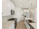 Modern kitchen with white cabinets, quartz countertops, stainless steel appliances, and a gas range at 16025 W Cottontail Ln, Surprise, AZ 85387