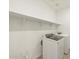 Laundry room with modern washer, dryer, and shelving at 16025 W Cottontail Ln, Surprise, AZ 85387