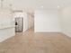 Open-concept living room boasts tile flooring and recessed lighting, adjacent to the kitchen at 16025 W Cottontail Ln, Surprise, AZ 85387