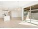 Open living space flows from the kitchen with a sliding glass door to the patio at 16025 W Cottontail Ln, Surprise, AZ 85387