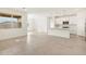 Bright open living space with a view into the kitchen with modern appliances at 16025 W Cottontail Ln, Surprise, AZ 85387