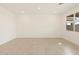 Bright, neutrally decorated room with tile floors and a window at 16025 W Cottontail Ln, Surprise, AZ 85387