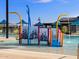 A colorful community splash pad featuring multiple sprayers, slides and climbing features for water fun at 16025 W Cottontail Ln, Surprise, AZ 85387