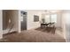 Bright home office features a large desk, two chairs, and carpet at 8143 E Obispo Ave, Mesa, AZ 85212