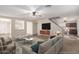 Open living room, featuring a stylish sofa and view into kitchen at 8143 E Obispo Ave, Mesa, AZ 85212